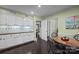 Eat-in kitchen with a breakfast table and chair and seamless access to other living areas at 4611 Cringle Ct, Charlotte, NC 28226