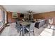 Sunroom features a dining table, and a comfortable seating area with brick wall accents at 4611 Cringle Ct, Charlotte, NC 28226