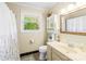 Cozy bathroom with a single sink vanity, mirrored cabinet, and floral shower curtain at 4901 White Oak Rd, Charlotte, NC 28210