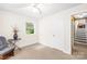 Bright bedroom with neutral carpet, a single window, and a stairway access point at 4901 White Oak Rd, Charlotte, NC 28210