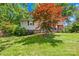 Charming split level home with lush landscaping and a well-manicured lawn at 4901 White Oak Rd, Charlotte, NC 28210