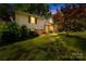 Charming split level home with lush landscaping and a well-manicured lawn at 4901 White Oak Rd, Charlotte, NC 28210