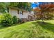 Charming split level home with lush landscaping and a well-manicured lawn at 4901 White Oak Rd, Charlotte, NC 28210