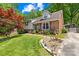 Well-maintained home featuring lush landscaping, a brick pathway and beautiful flowering plants at 4901 White Oak Rd, Charlotte, NC 28210