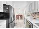 Bright kitchen featuring stainless steel refrigerator and dining area with tile flooring at 4901 White Oak Rd, Charlotte, NC 28210