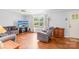Bright living room featuring hardwood floors, a ceiling fan and a large window at 4901 White Oak Rd, Charlotte, NC 28210