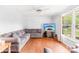 Bright living room featuring hardwood floors, a ceiling fan and a large window at 4901 White Oak Rd, Charlotte, NC 28210