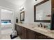 Bathroom features double sink vanity, granite counters, dark wood cabinets, and tile floors at 615 Welker St, Charlotte, NC 28204