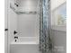 Bathroom showcasing subway tile shower and tub combination with updated fixtures and window at 615 Welker St, Charlotte, NC 28204