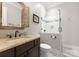 Bathroom featuring granite vanity, framed mirror, and tiled shower with glass door at 615 Welker St, Charlotte, NC 28204