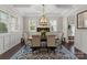 Elegant dining room featuring wainscoting, a coffered ceiling, and ample natural light for Gathering gatherings at 615 Welker St, Charlotte, NC 28204