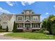 Charming two-story home with gray siding, a well-manicured lawn, and tasteful landscaping creating inviting curb appeal at 615 Welker St, Charlotte, NC 28204