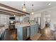 Open-concept kitchen with a large island, stainless steel appliances, and seamless flow into the adjacent living area at 615 Welker St, Charlotte, NC 28204