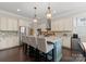 Spacious kitchen with stainless steel appliances, granite countertops, and an island with bar seating at 615 Welker St, Charlotte, NC 28204