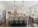 Bright, open-concept kitchen with stainless appliances, granite counters, and inviting breakfast bar seating at 615 Welker St, Charlotte, NC 28204
