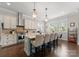 Well-lit kitchen with stainless steel appliances, central island, and views of the dining area at 615 Welker St, Charlotte, NC 28204