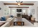 Inviting living room features wood beams, a stone fireplace, and a comfortable seating area at 615 Welker St, Charlotte, NC 28204