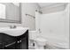 Bathroom features a tub with shower, a white toilet, a dark vanity, and gray flooring for a sleek design at 6712 Santa Maria Ln, Charlotte, NC 28227
