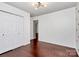 Bright bedroom features hardwood floors, neutral paint, bright window, closet, and modern lighting at 6712 Santa Maria Ln, Charlotte, NC 28227