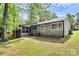 Back exterior of home with screened porch and partially fenced yard with patio at 6712 Santa Maria Ln, Charlotte, NC 28227