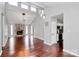 Open-concept living space with hardwood floors, a vaulted ceiling, stone fireplace, and modern light fixtures at 6712 Santa Maria Ln, Charlotte, NC 28227