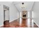 Bright living room featuring hardwood floors, a stone fireplace, and a vaulted ceiling at 6712 Santa Maria Ln, Charlotte, NC 28227
