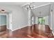 Bright and airy living room with hardwood floors, modern light fixture, and access to an outdoor patio at 6712 Santa Maria Ln, Charlotte, NC 28227