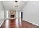 Spacious living room showcasing a stone fireplace, hardwood floors, and ample natural light at 6712 Santa Maria Ln, Charlotte, NC 28227