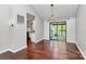 Living area featuring hardwood floors, a sliding glass door to an outdoor patio, and modern light fixtures at 6712 Santa Maria Ln, Charlotte, NC 28227