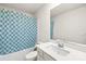 Clean bathroom with a modern vanity and a tub with a stylish blue patterned shower curtain at 7004 Everly Commons Ln, Tega Cay, SC 29708