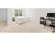 Well-lit bedroom with neutral carpeting, a comfortable bed, and a workspace area at 7004 Everly Commons Ln, Tega Cay, SC 29708