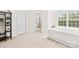 Bright bedroom with a large window and neutral decor showcasing a modern design at 7004 Everly Commons Ln, Tega Cay, SC 29708