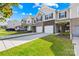 Charming townhomes feature brick accents, attached garages, and manicured lawns at 7004 Everly Commons Ln, Tega Cay, SC 29708