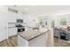 Open-concept kitchen with a large island, stainless steel appliances, and a view of the dining area at 7004 Everly Commons Ln, Tega Cay, SC 29708