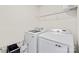 Efficient laundry room with modern washer and dryer units and a storage shelf at 7004 Everly Commons Ln, Tega Cay, SC 29708