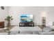 Bright living room with a large television, modern decor, and wood-look flooring at 7004 Everly Commons Ln, Tega Cay, SC 29708