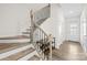Elegant staircase with decorative iron railing and hardwood steps at 7004 Everly Commons Ln, Tega Cay, SC 29708