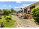 Home's backyard featuring patio, green grass, and lush plants at 7209 Marley Cir, Charlotte, NC 28214