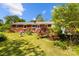 Brick house backyard with patio, plants, and green grass at 7209 Marley Cir, Charlotte, NC 28214