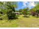 Lush backyard with beautiful mature trees and green lawn at 7209 Marley Cir, Charlotte, NC 28214