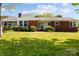 Charming single-story brick home with manicured lawn and well-maintained landscaping at 7209 Marley Cir, Charlotte, NC 28214