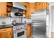 Kitchen with stainless steel appliances, wooden cabinets, and tile backsplash at 7209 Marley Cir, Charlotte, NC 28214