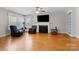 Inviting living room featuring hardwood floors, a fireplace, and natural light from the windows at 7209 Marley Cir, Charlotte, NC 28214