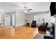 Bright living room featuring hardwood floors, large windows, and comfortable seating near the fireplace at 7209 Marley Cir, Charlotte, NC 28214