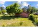 Backyard outbuilding and storage shed shaded by green trees at 7209 Marley Cir, Charlotte, NC 28214
