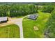 Aerial shot of an estate with a long driveway and surrounding trees and landscaping at 725 Bradshaw Rd, Mt Ulla, NC 28125