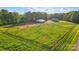 Expansive green acreage with barn and two story house surrounded by mature trees at 725 Bradshaw Rd, Mt Ulla, NC 28125