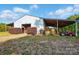 Large barn features sheltered areas with hay storage and equipment at 725 Bradshaw Rd, Mt Ulla, NC 28125