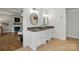 Bathroom with double vanity and stone countertops, adjacent to bedroom with fireplace at 725 Bradshaw Rd, Mt Ulla, NC 28125