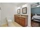 Bathroom with double vanity, granite countertops, and tiled floors with an open doorway to bedroom at 725 Bradshaw Rd, Mt Ulla, NC 28125